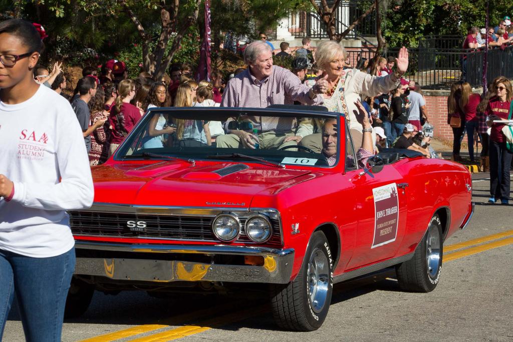 President John Thrasher and his wife, Jean, wave to the crowd during the Homecoming Parade in November 2014.
