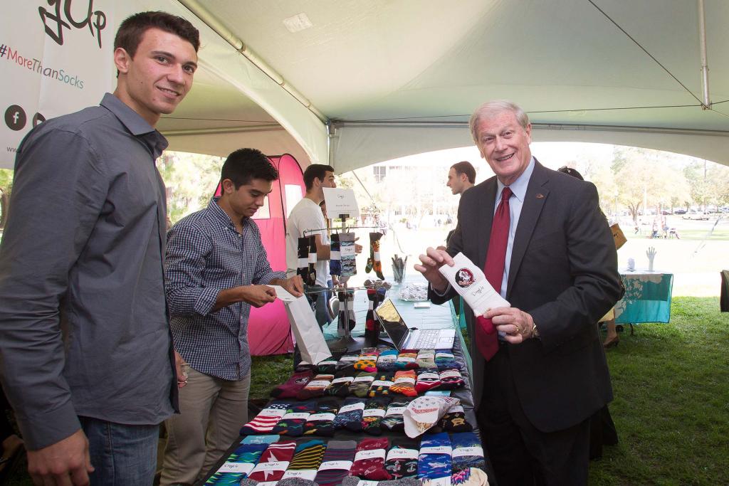President John Thrasher talks to students entrepreneurs during an event on Landis Green in 2015.
