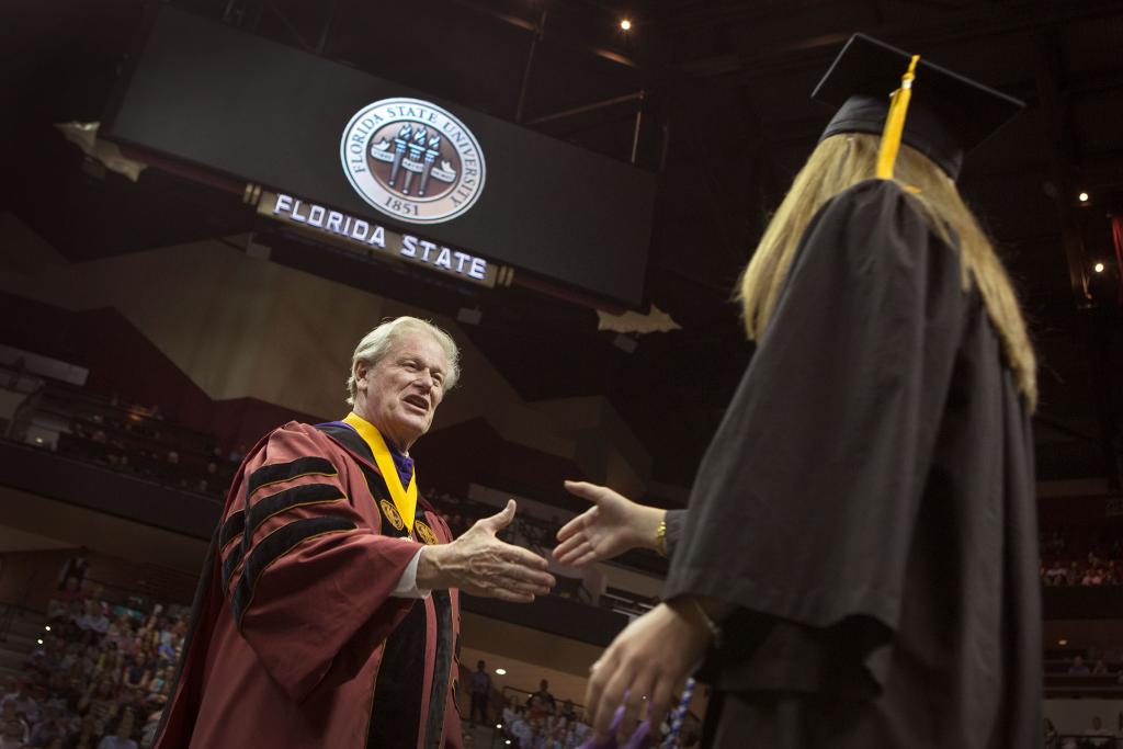 President John Thrasher congratulates a graduate during 2016 spring commencement.