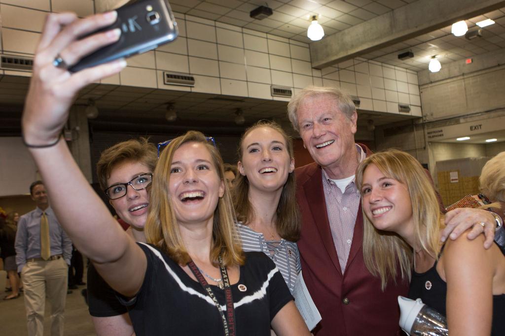 President John Thrasher takes selfies with students following New Student Convocation at the Tucker Center on Aug. 28, 2016.
