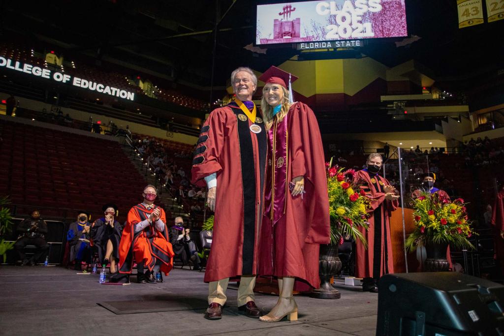 President John Thrasher with granddaughter Ashley Williamson, who graduated with a master's degree in special education, during spring commencement in April 2021.