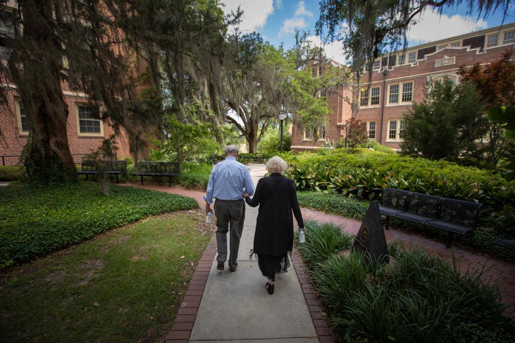 John and Jean Thrasher walking on campus in May 2021.